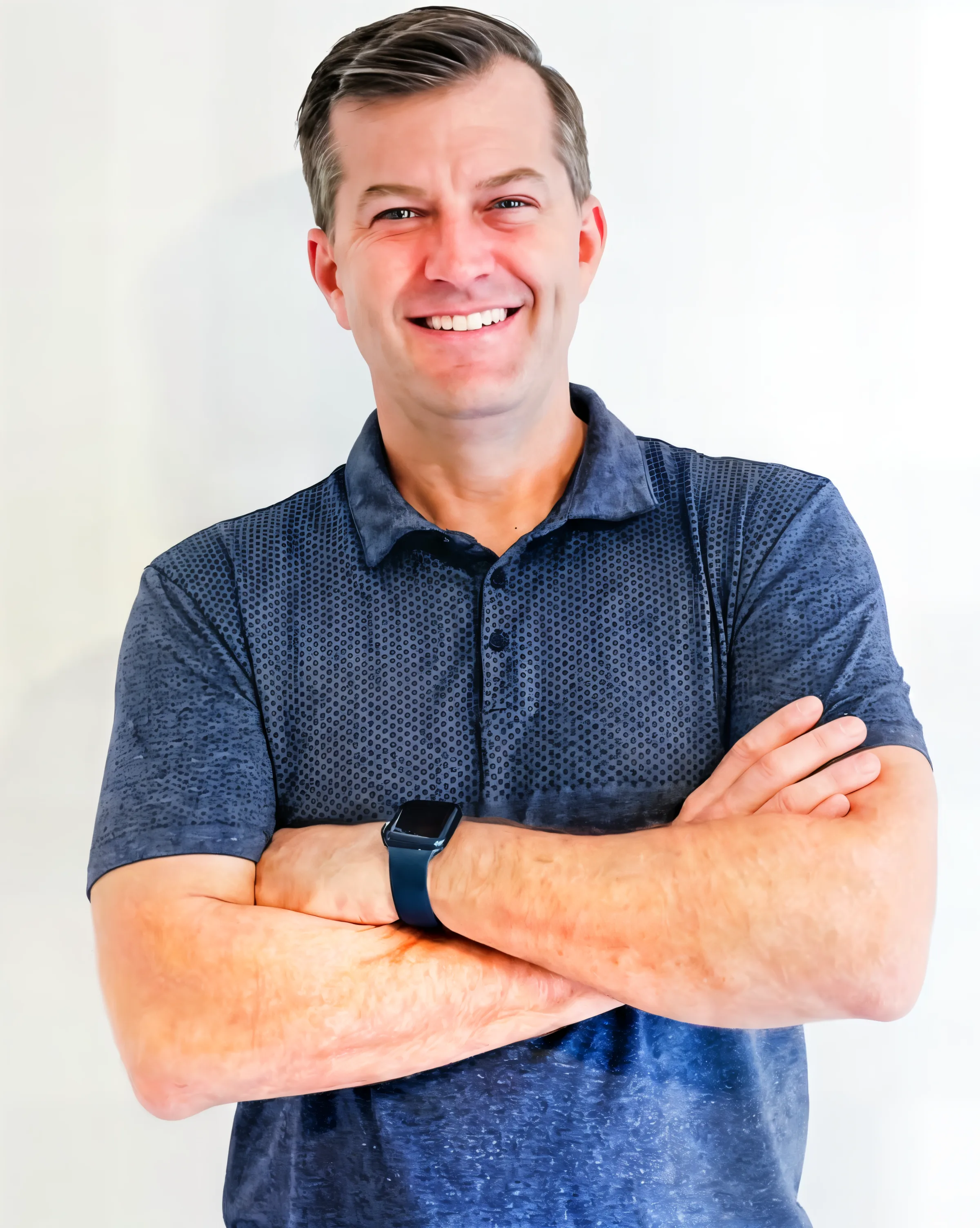 Brad Pleimann, owner of R&R Repair & Remodel, smiling in a navy polo shirt.