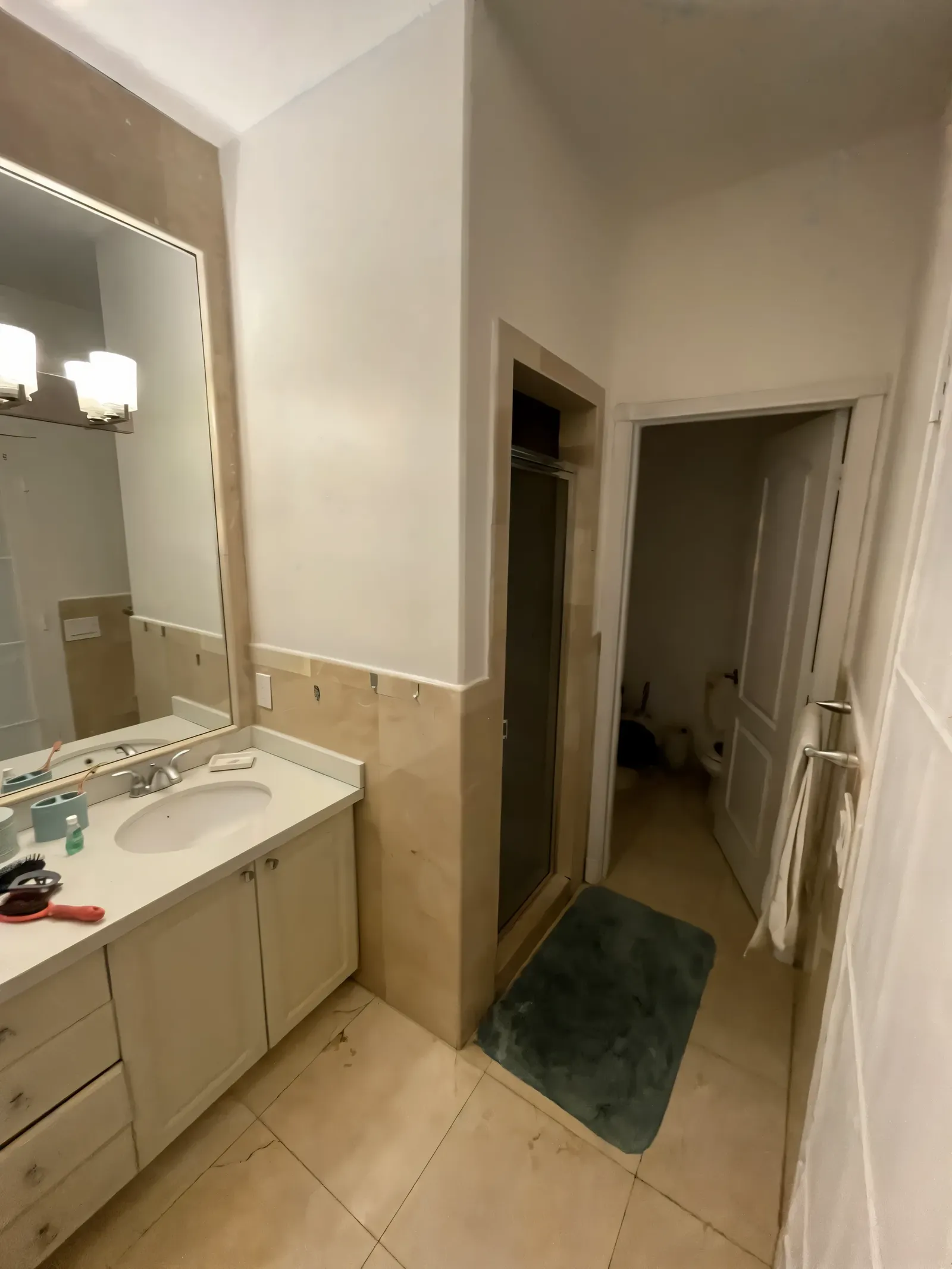 Closed-in 1990s primary bathroom with a builder-grade vanity before the remodel